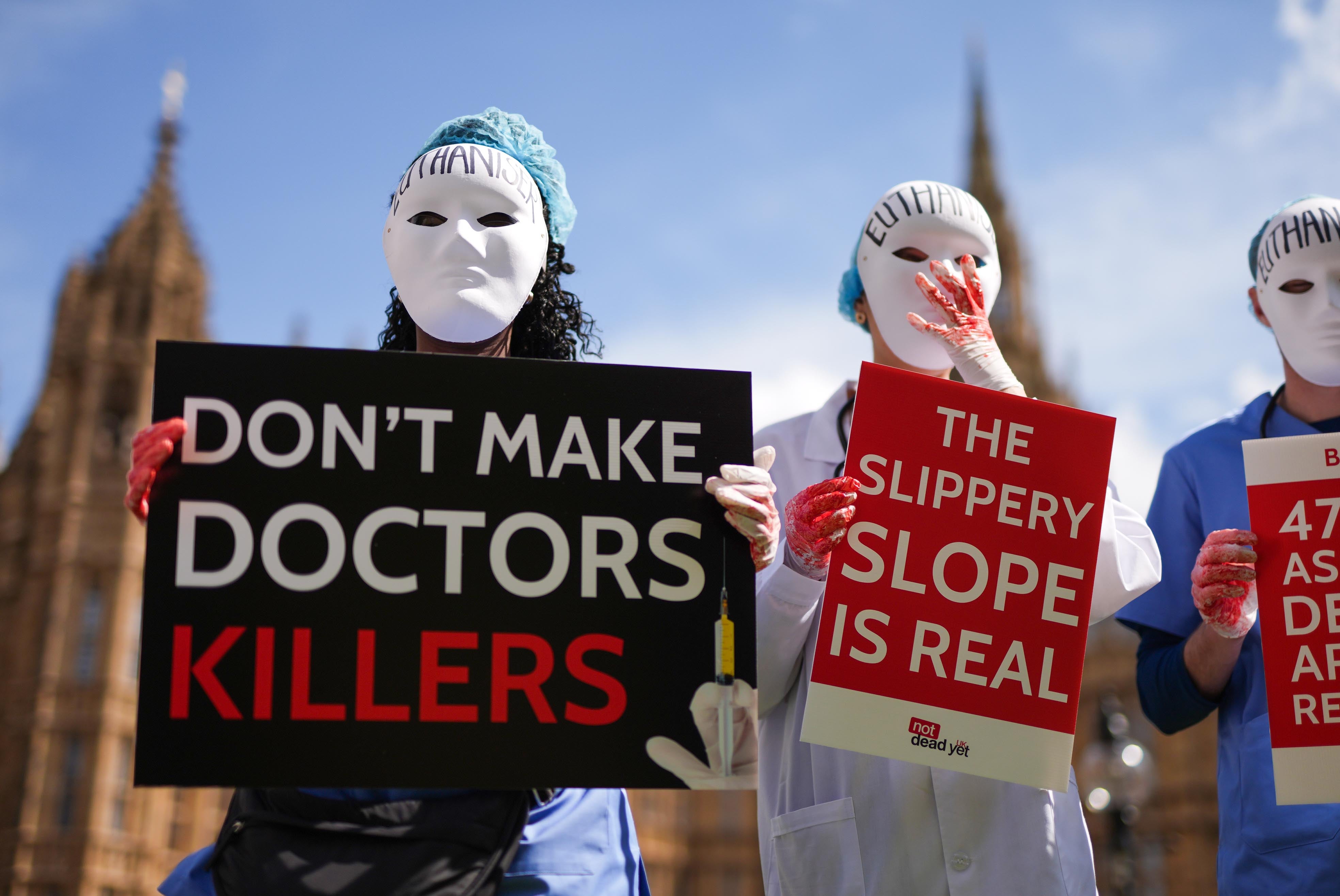 Campaigners protest outside parliament ahead of a debate in the House of Commons on assisted dying