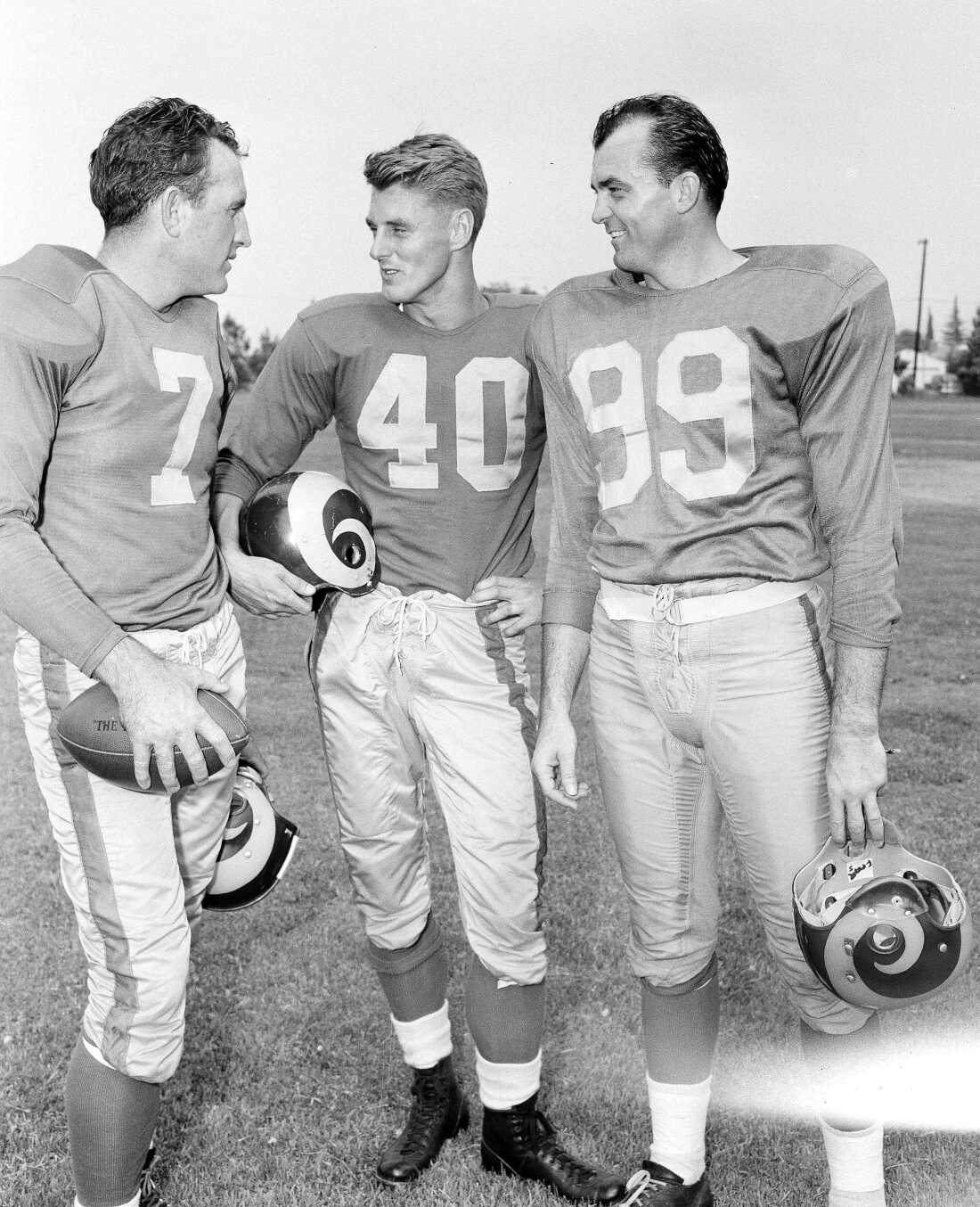 The Los Angeles Rams high-powered passing combination, probably football's best, gets together at Redlands, Calif., as the NFL titleholders began drills July 23, 1952. From left: quarterback Bob Waterfield and ends Elroy Hirsch and Tom Fears.