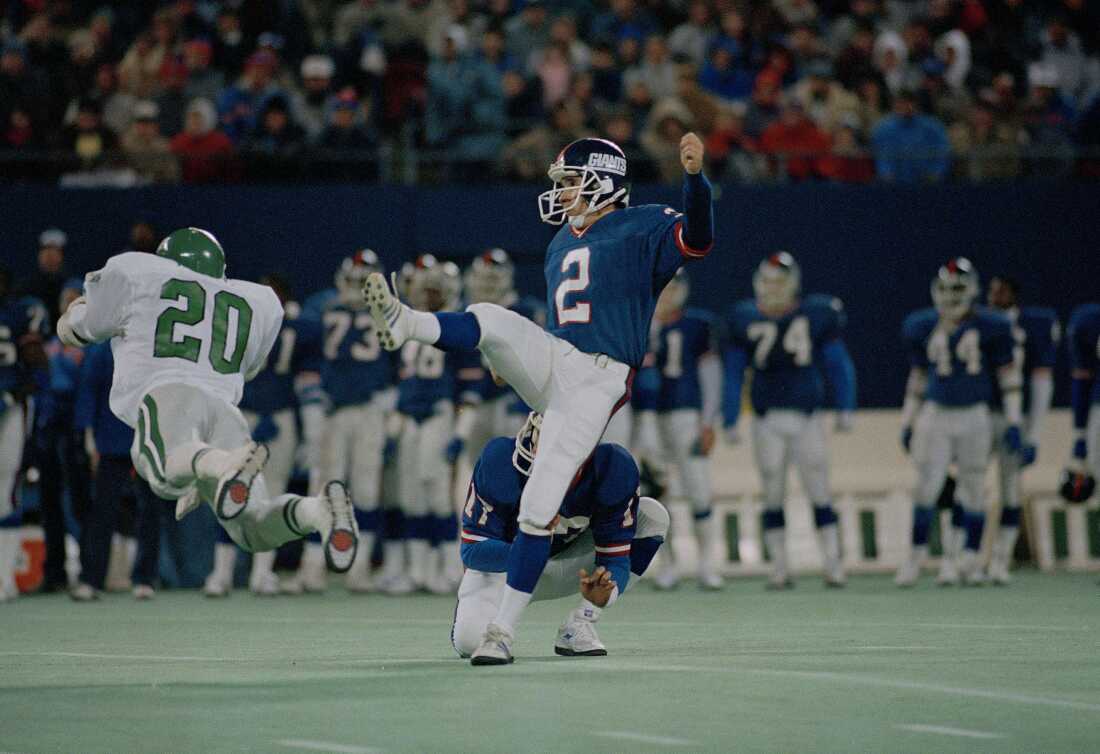 Seth Joyner (not shown) of the Philadelphia Eagles blocks a field goal attempt by kicker Raul Allegre (2) of the New York Giants, as Andre Waters (20) also makes a diving effort at Giants Stadium in East Rutherford, N.J., Dec. 6, 1987. Allegre later kicked a 28-yard field goal to give the Giants a 23-20 win over the Eagles.