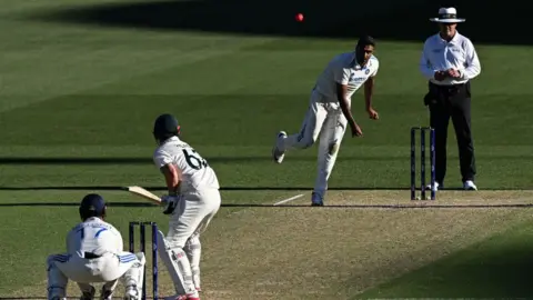 AFP Ravichandran Ashwin bowls to Australia's Travis Head on the second day of the second Test cricket match between Australia and India at the Adelaide Oval in Adelaide on December 7, 2024.