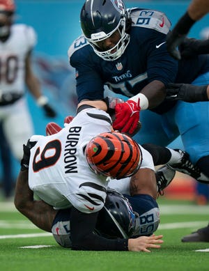 Tennessee Titans linebacker Harold Landry III (58) sacks Cincinnati Bengals quarterback Joe Burrow (9) as defensive tackle T'Vondre Sweat (93) strips the ball away during their game at Nissan Stadium in Nashville, Tenn., Sunday, Dec. 15, 2024.