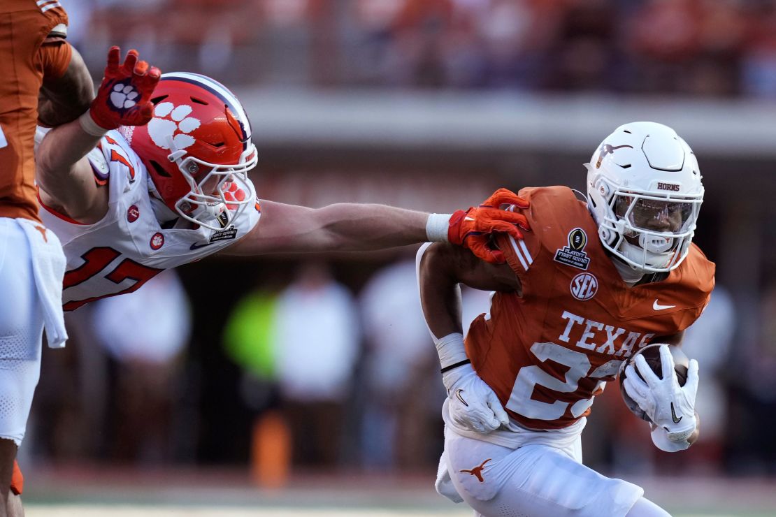 Texas running back Jaydon Blue runs form Clemson linebacker Wade Woodaz  during the first half.