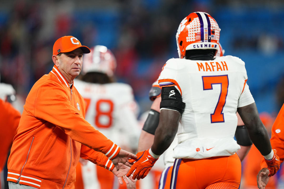 CHARLOTTE, NORTH CAROLINA - DECEMBER 07: Phil Mafah #7 and head coach Dabo Swinney of the Clemson Tigers high five before the 2024 ACC Football Championship at Bank of America Stadium on December 07, 2024 in Charlotte, North Carolina. (Photo by Grant Halverson/Getty Images)