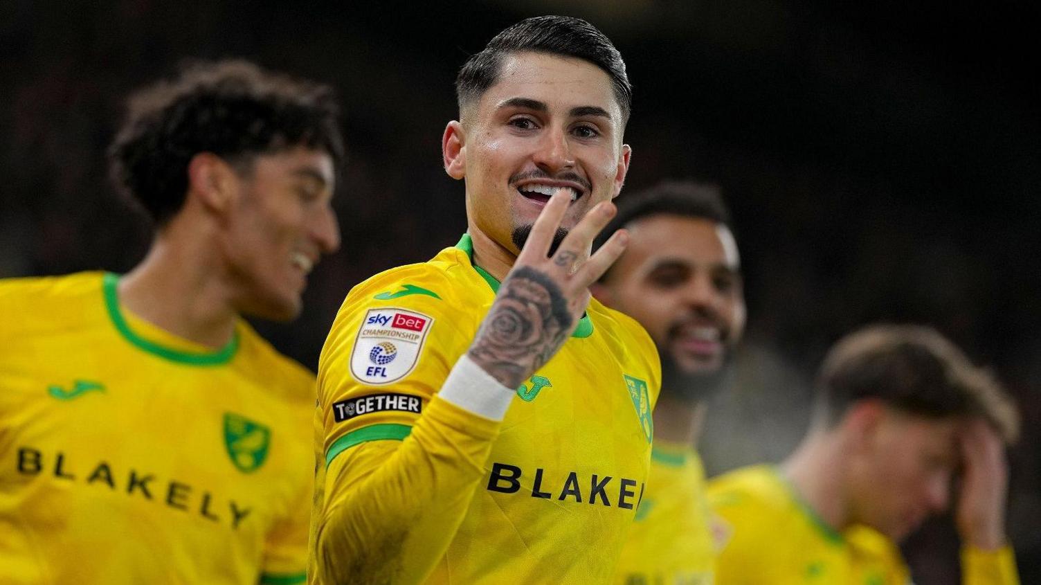 Norwich forward Borja Sainz holds up three fingers after scoring a hat-trick against Plymouth