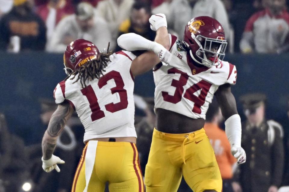 USC linebacker Mason Cobb, left, and defensive end Braylan Shelby celebrate in the first half Friday.