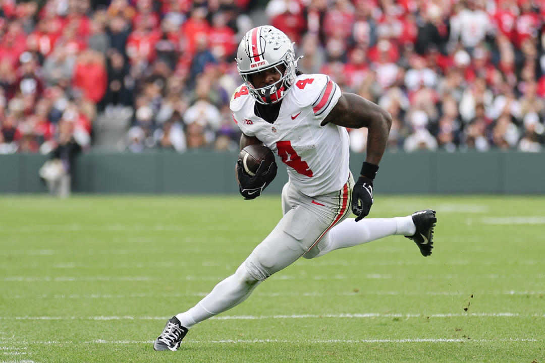 CHICAGO, ILLINOIS - NOVEMBER 16: Jeremiah Smith #4 of the Ohio State Buckeyes runs with the ball after a reception against the Northwestern Wildcats during the first half at Wrigley Field on November 16, 2024 in Chicago, Illinois. (Photo by Michael Reaves/Getty Images)