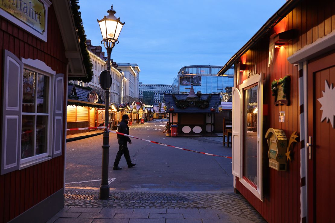 A police officer walks through the shuttered Christmas market in Magdeburg on December 21.