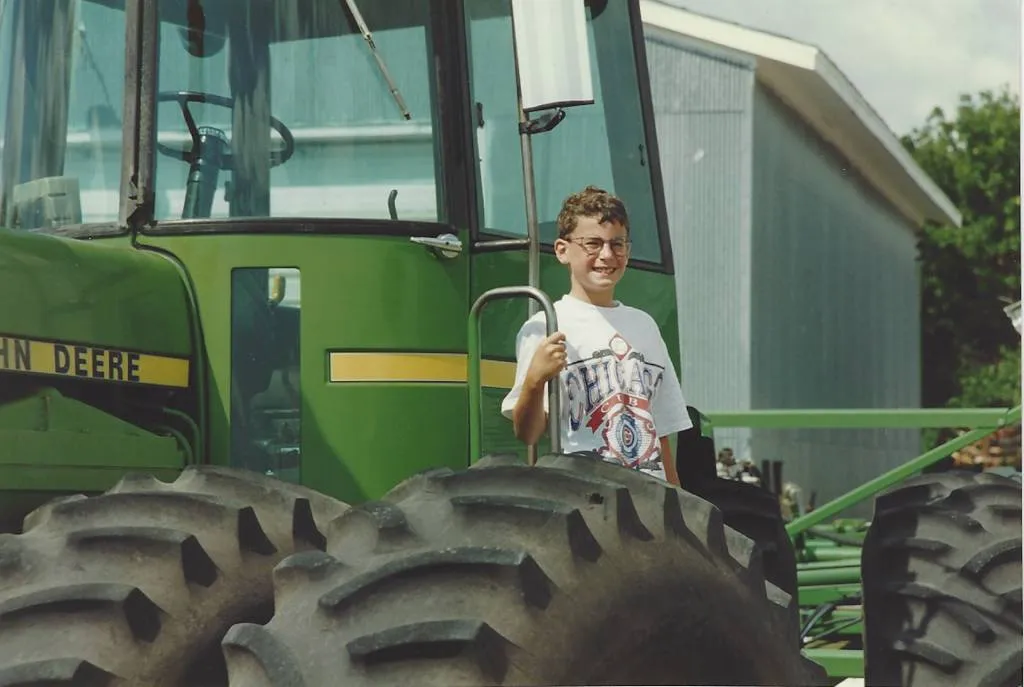 Joel Feder standing on the combine