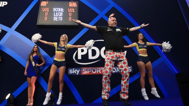 Peter Wright dances on the stage after his walk on during day thirteen of the William Hill World Darts Championship at Alexandra Palace, London.
