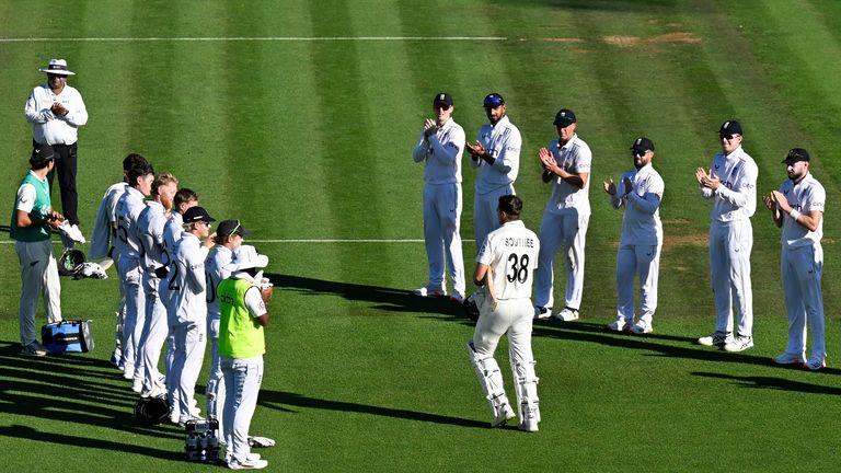 England players form a guard of honor as New Zealand batsman Tim Southee walks out to bat in his final Test match