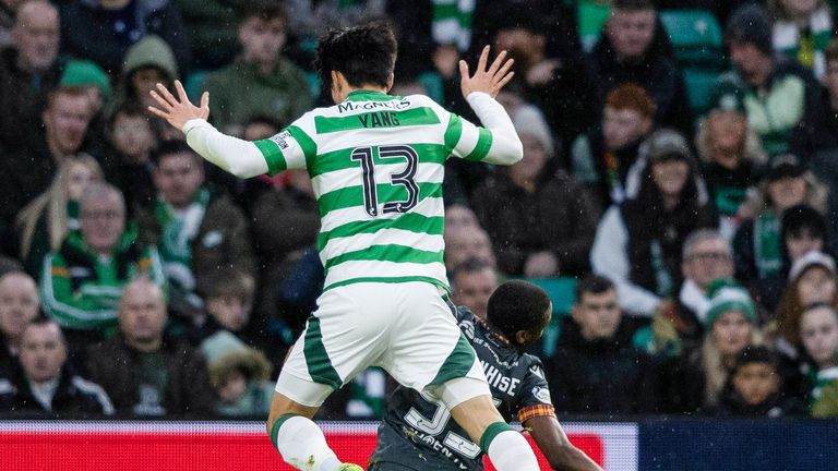 GLASGOW, SCOTLAND - DECEMBER 26: Motherwell's Tawanda Maswanhise (R) goes down under a challenge from Celtic's Hyunjun Yang but is booked for simulation during a William Hill Premiership match between Celtic and Motherwell at Celtic Park, on December 26, 2024, in Glasgow, Scotland. (Photo by Craig Foy / SNS Group)