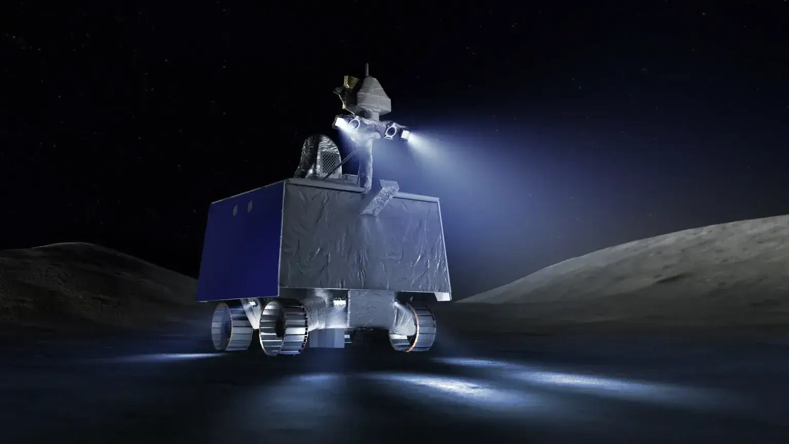 a rectangular-bodied rover with three visible ribbed wheels, shines two lights from the top of a short mast at the top front of its body. It's visible side is a solar panel. The lights illuminate the grey surface immediately in front of the rover. A black sky hangs above.