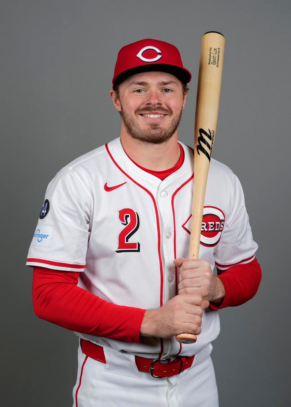 Gavin Lux holds bat in Reds portrait.