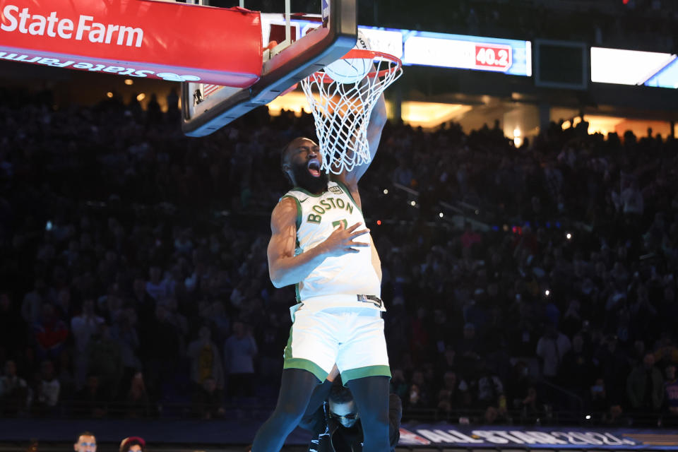 INDIANAPOLIS, INDIANA - FEBRUARY 17: Jaylen Brown #7 of the Boston Celtics dunks the ball over Donovan Mitchell #45 of the Cleveland Cavaliers in the 2024 AT&T Slam Dunk contest during the State Farm All-Star Saturday Night at Lucas Oil Stadium on February 17, 2024 in Indianapolis, Indiana. NOTE TO USER: User expressly acknowledges and agrees that, by downloading and or using this photograph, User is consenting to the terms and conditions of the Getty Images License Agreement. (Photo by Stacy Revere/Getty Images)