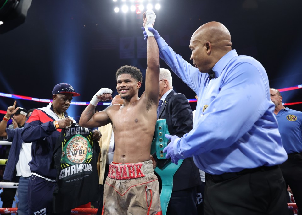 Shakur Stevenson, a world-class boxer, raises his arm in victory.