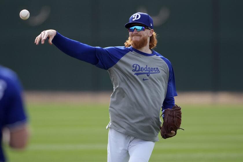 Los Angeles Dodgers' Dustin May throws during a baseball spring training workout.