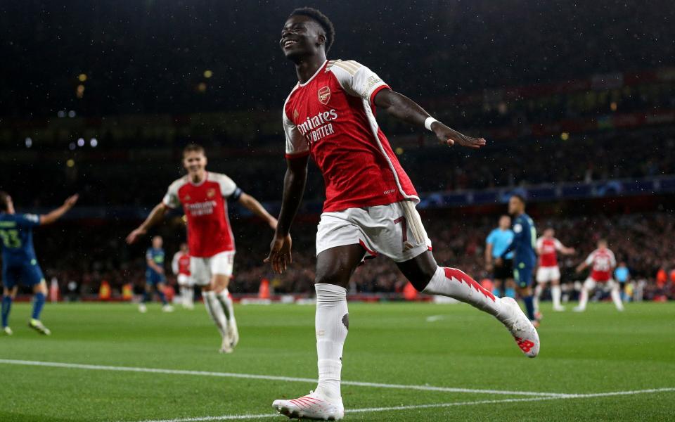 Bukayo Saka celebrates scoring for Arsenal against PSV in the Champions League