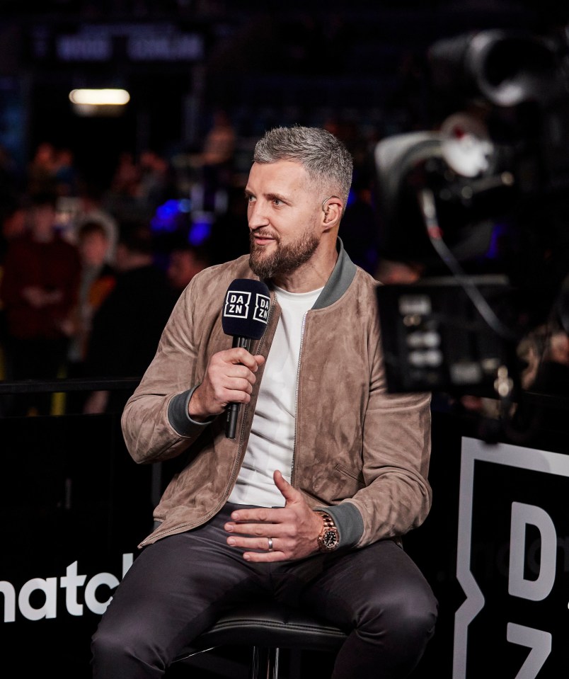 Carl Froch holding a microphone during an interview.