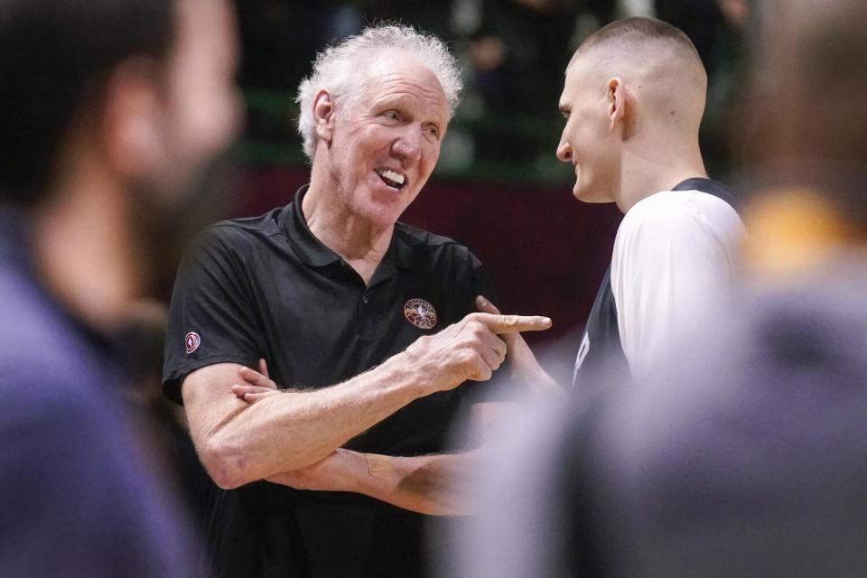 Bill Walton, left, jokes with Denver Nuggets center Nikola Jokic.