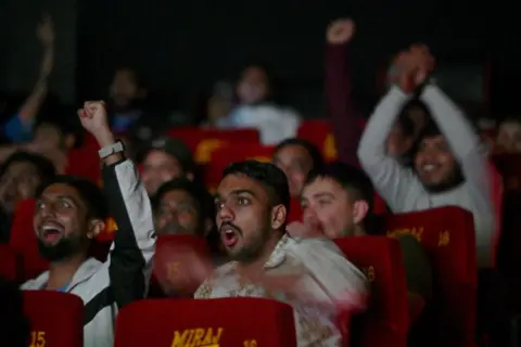 AFP : People gathered at the GIP Mall Miraj cinema hall in Sector 38A to watch the India-Pakistan match of the ICC Champions Trophy 2025, on February 23, 2025 in Noida, India