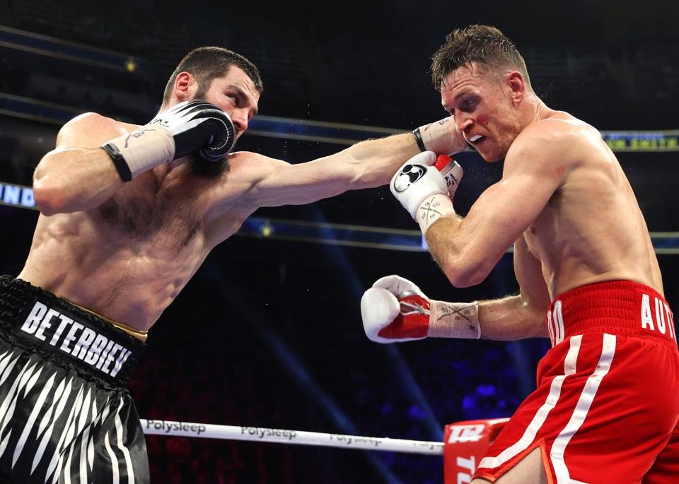 Artur Beterbiev punches Callum Smith in a boxing match.