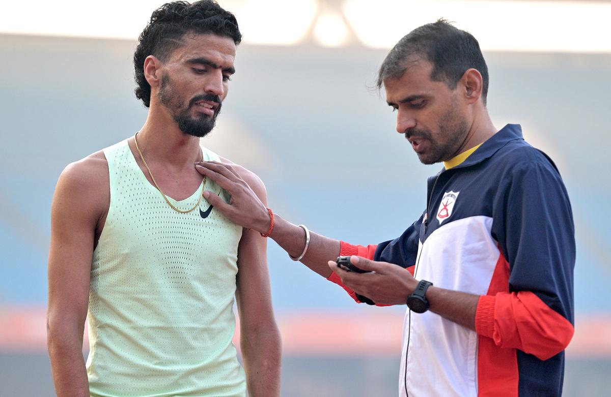 Indian athlete Gulveer Singh with coach during his practice session in JLN Stadium in New Delhi on December 03, 2024.