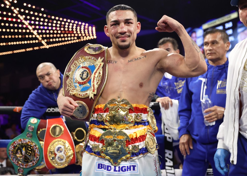 Teofimo Lopez, WBO super-lightweight world champion, holding his championship belts.