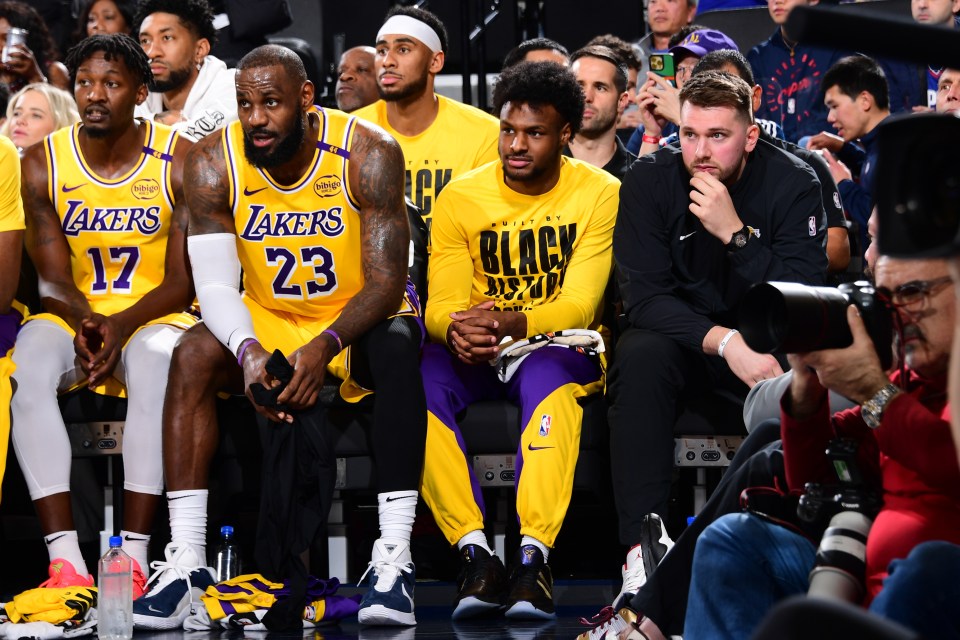 Luka sat on the Lakers' bench against the Clippers next to LeBron and Bronny James