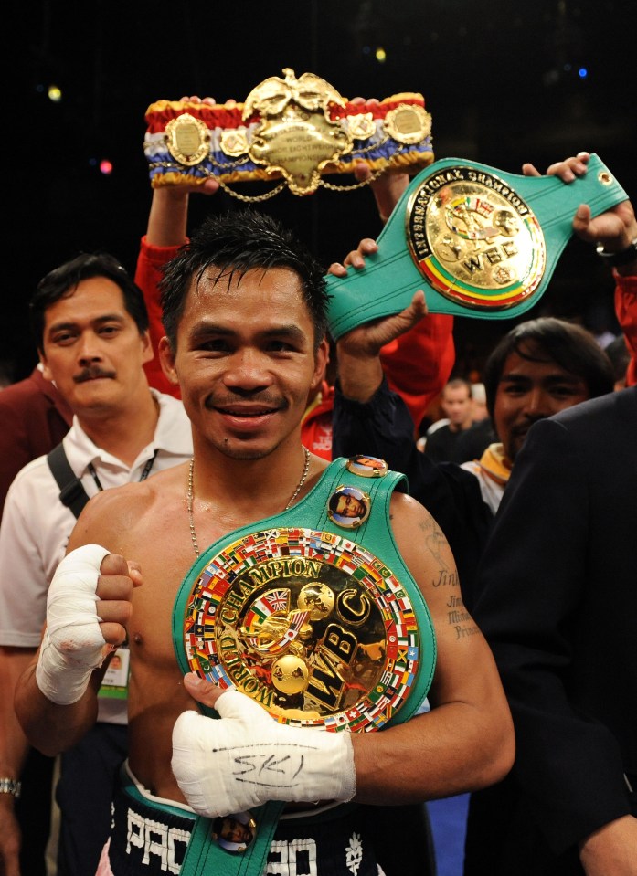 LAS VEGAS - JUNE 28:  Manny Pacquiao of the Philippines poses with his belts after he knocks out David Diaz during the ninth round of the WBC Lightweight Championship at the Mandalay Bay Events Center on June 28, 2008 in Las Vegas, Nevada.  (Photo by Harry How/Getty Images)