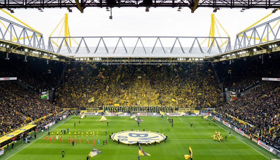 A full stadium of Borussia Dortmund fans before a Bundesliga match.