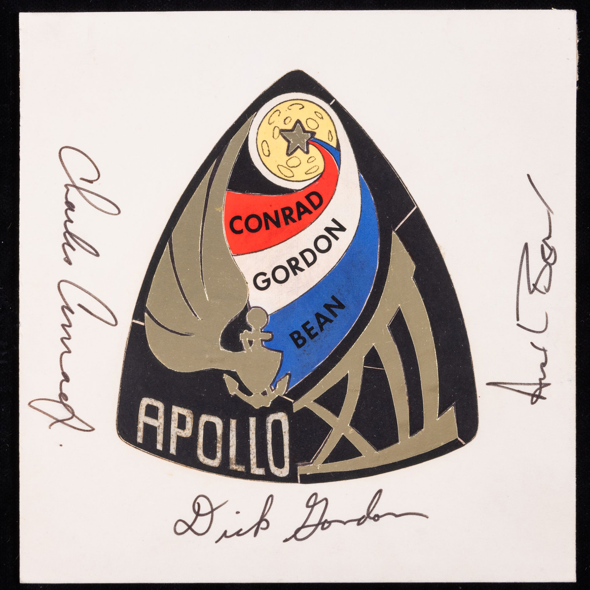 an ink rendering of a mission patch design with the autographs of the crew added around it