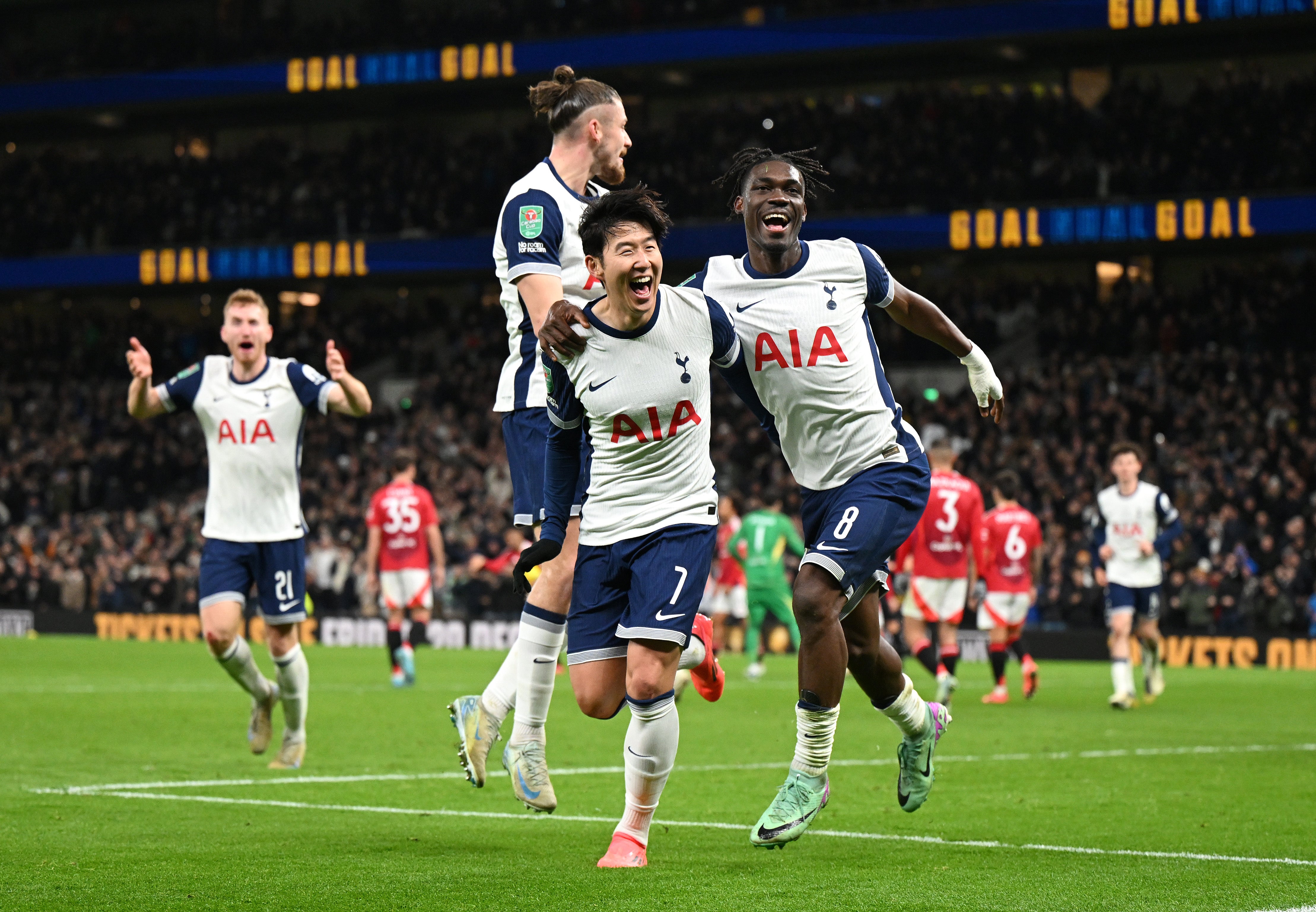 Son Heung Min of Tottenham celebrates with teammates Radu Dragusin and Yves Bissouma against Man Utd