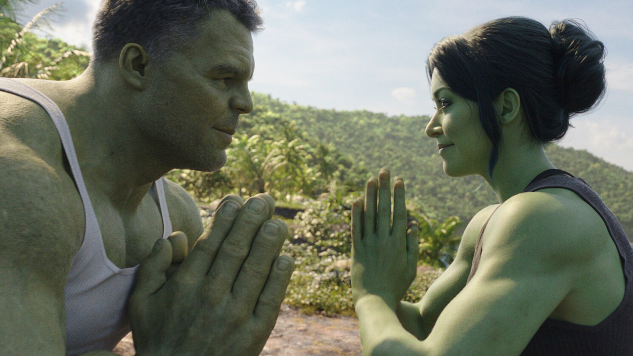 Two green-skinned people, one man and one woman, facing each other with their hands together in a prayer position.