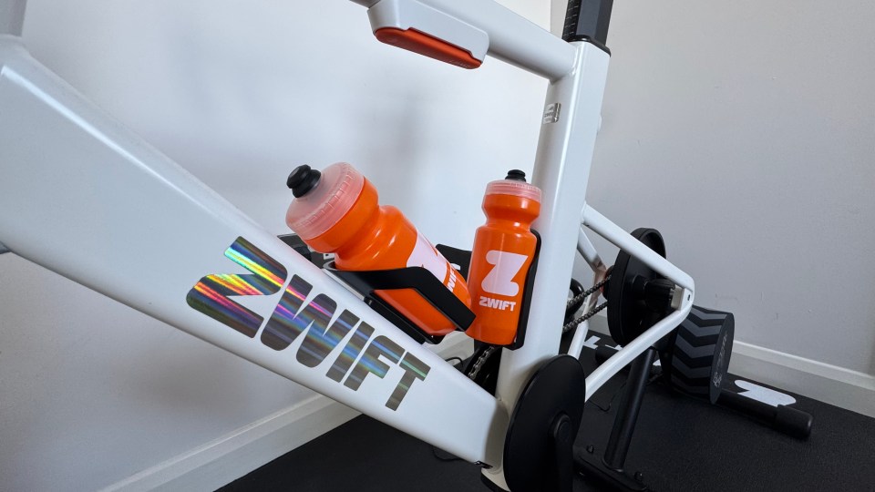 Zwift bike with two orange water bottles.