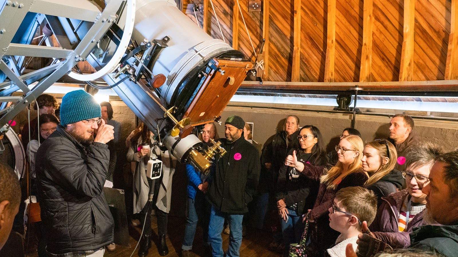 People in front of a telescope.