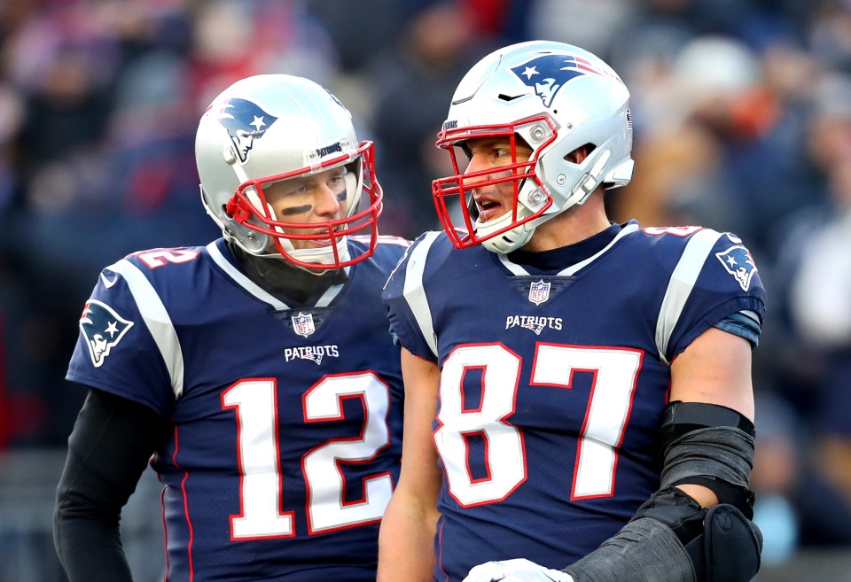 FOXBOROUGH, MASSACHUSETTS - JANUARY 13: Tom Brady #12 of the New England Patriots reacts with Rob Gronkowski #87 during the third quarter in the AFC Divisional Playoff Game against the Los Angeles Chargers at Gillette Stadium on January 13, 2019 in Foxborough, Massachusetts. (Photo by Maddie Meyer/Getty Images)