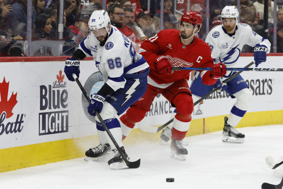 Feb 8, 2025; Detroit, Michigan, USA; Tampa Bay Lightning right wing Nikita Kucherov (86) and Detroit Red Wings center Dylan Larkin (71) battle for the puck in the first period at Little Caesars Arena<p>Rick Osentoski&comma; Imagn Images</p>