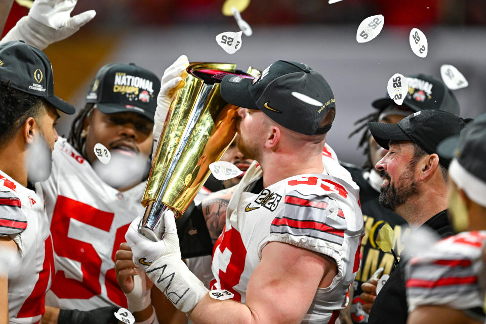 ATLANTA, GA  JANUARY 20:  Defensive End Jack Sawyer #33 of the Ohio State Buckeyes kisses the trophy following the conclusion of the Ohio State Buckeyes versus Notre Dame Fighting Irish College Football Playoff National Championship game on January 20, 2025, at Mercedes-Benz Stadium in Atlanta, GA.  (Photo by Rich von Biberstein/Icon Sportswire via Getty Images)