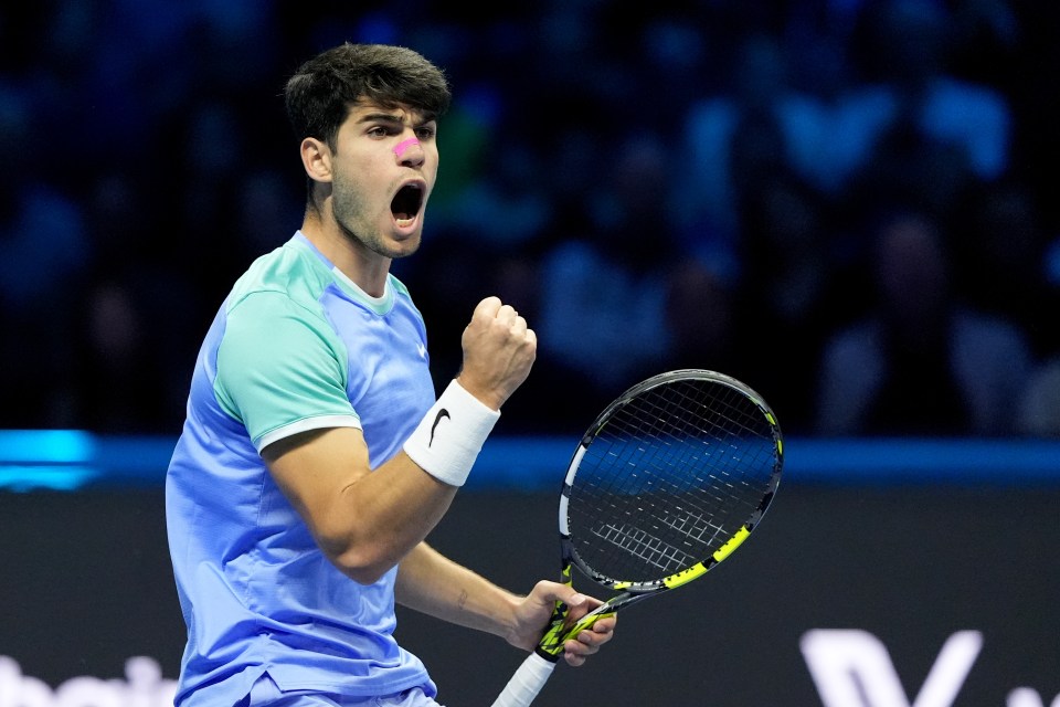 Carlos Alcaraz celebrating a point during a tennis match.