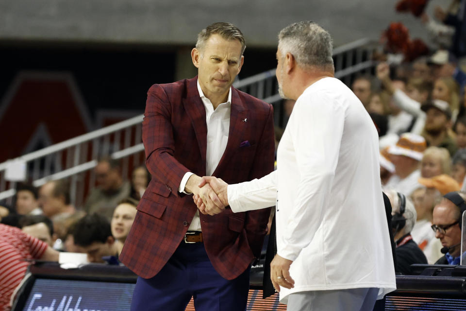 Alabama head coach Nate Oats, left, shakes hands with Auburn head coach Bruce Pearl, right, during the first half of an NCAA college basketball game Saturday, Feb. 11, 2023, in Auburn, Ala. (AP Photo/Butch Dill)