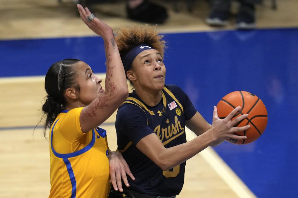 Notre Dame's Hannah Hidalgo, right, is fouled by Pittsburgh 's MaKayla Elmore during the first half of the an NCAA college basketball game in Pittsburgh, Thursday, Feb. 13, 2025. (AP Photo/Gene J. Puskar)