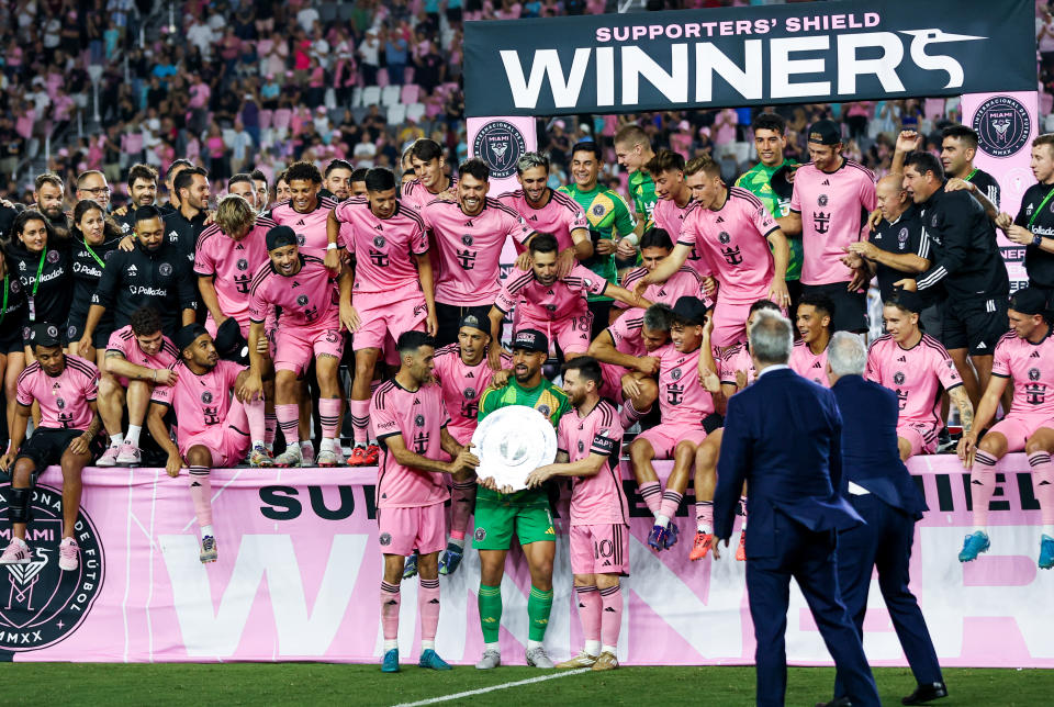 Inter Miami's Spanish midfielder #05 Sergio Busquets, Uruguayan forward #09 Luis Suarez, US goalkeeper #01 Drake Callender and Argentine forward #10 Lionel Messi hold the Supporters' Shield after the Major League Soccer (MLS) football match against New England Revolution at Chase Stadium in Fort Lauderdale, Florida, October 19, 2024. (Photo by Chris Arjoon / AFP) (Photo by CHRIS ARJOON/AFP via Getty Images)