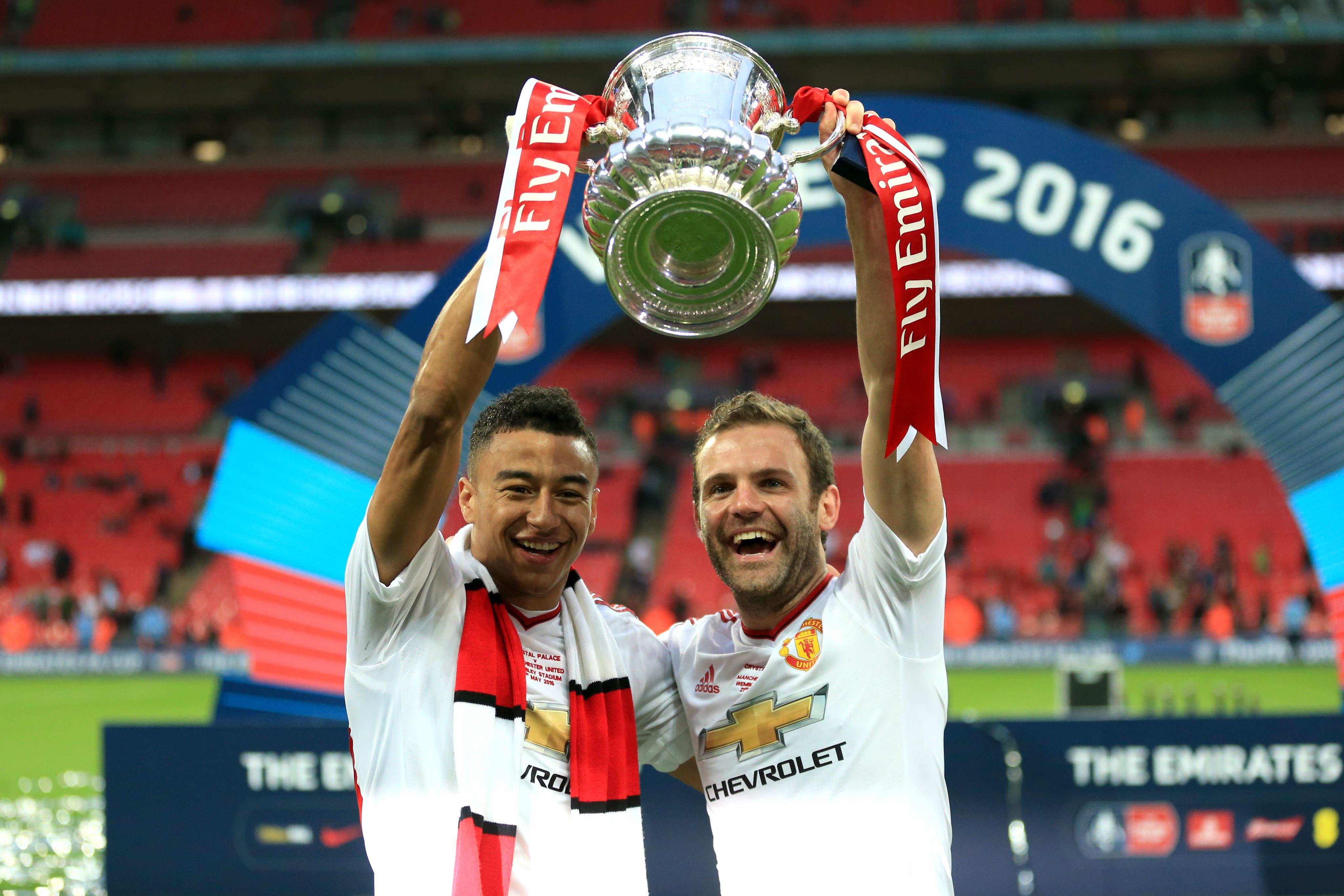 Jesse Lingard lifts the FA Cup while at Manchester United