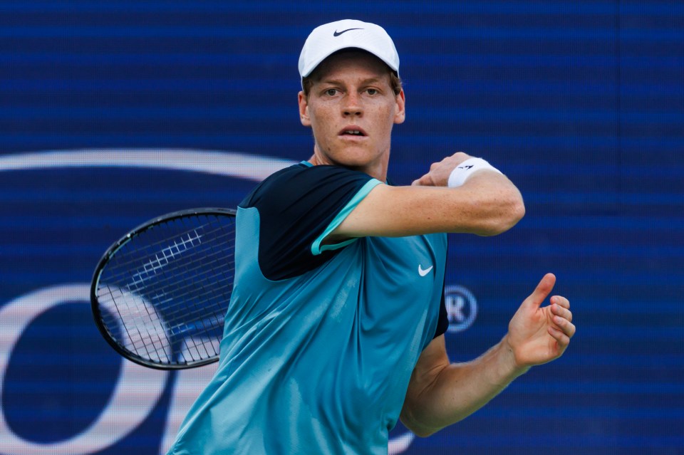 Jannik Sinner playing tennis.