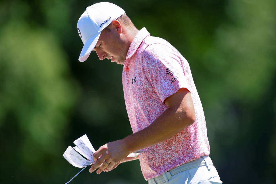 Golfers hand in their scorecards to officials after their rounds