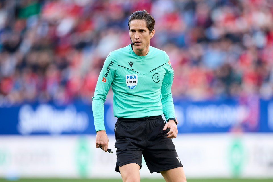 Jose Luis Munuera Montero, a FIFA referee, on a soccer field.