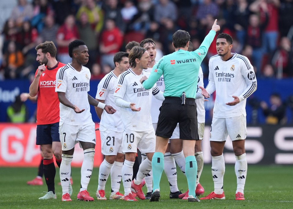 Real Madrid players protesting a referee's decision.