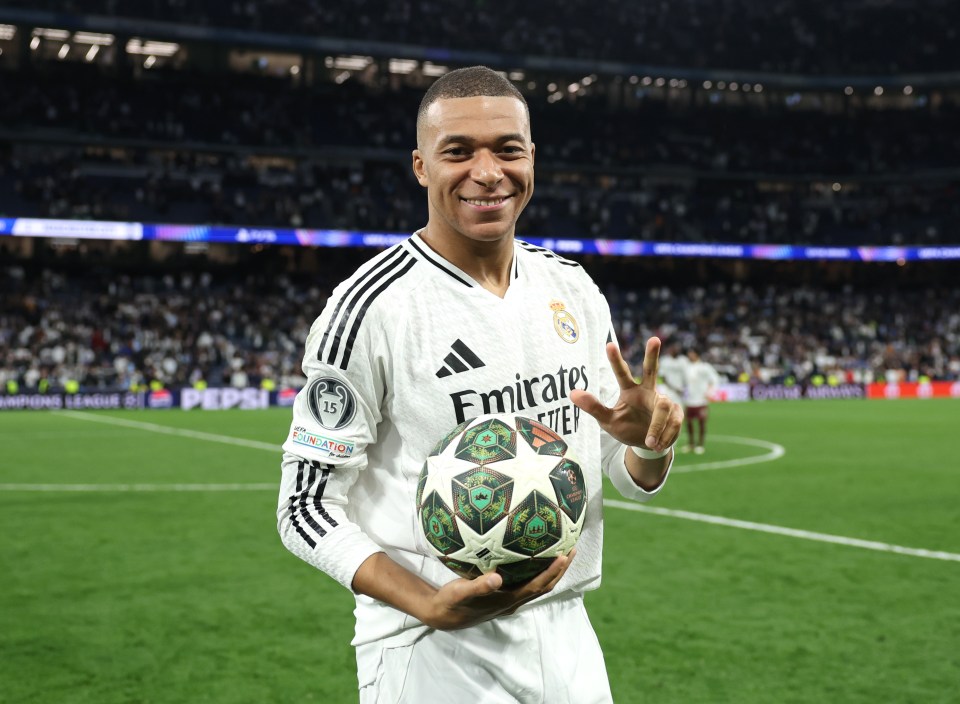 Kylian Mbappé of Real Madrid holding the Player Of The Match award after a Champions League victory.