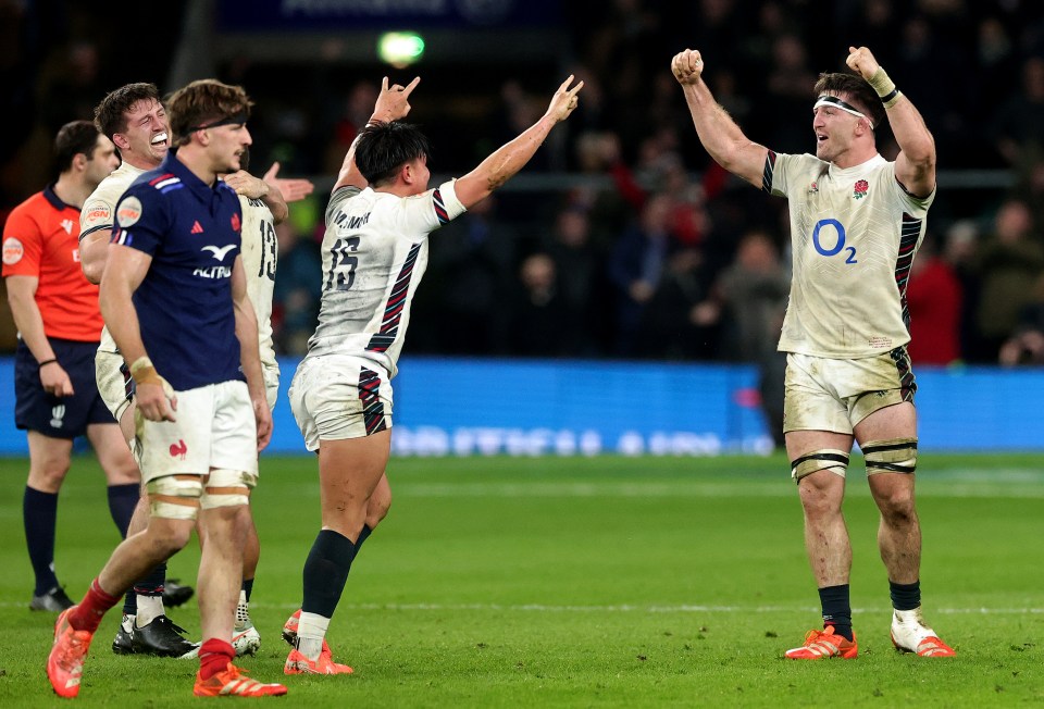 England rugby players celebrating a victory.