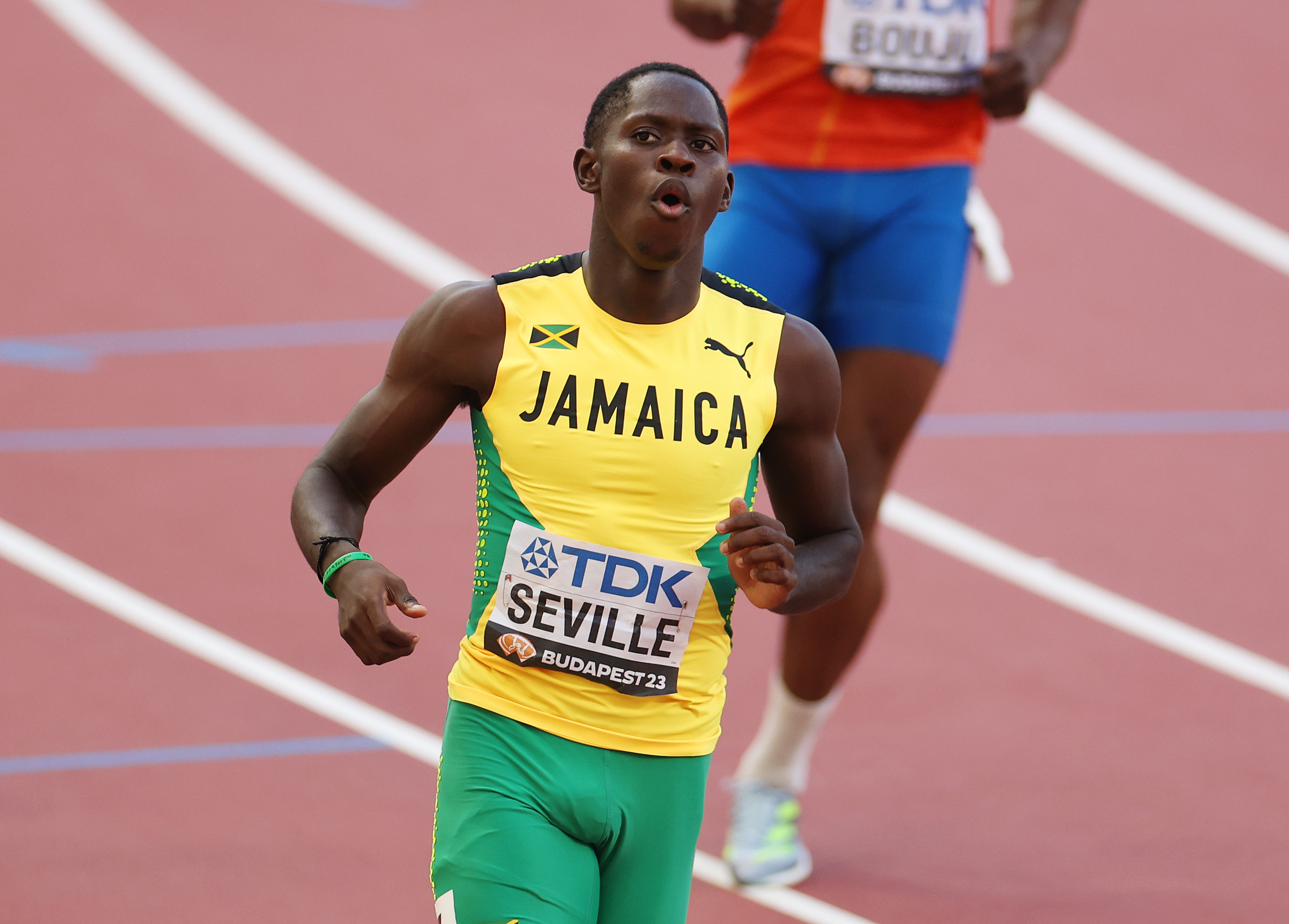 Oblique Seville of Team Jamaica reacting after crossing the finish line in the Men's 100m Semi-Final.